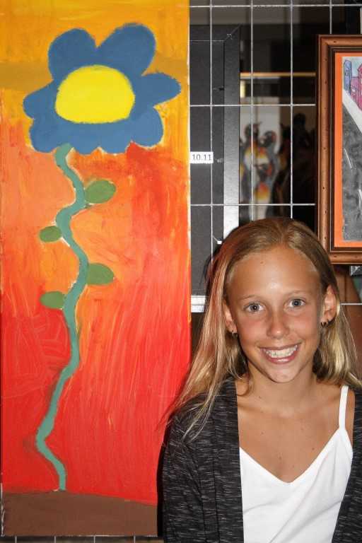 Emma Worthington with her floral art at Brushes by the Sea, the annual art show in Rainbow Beach