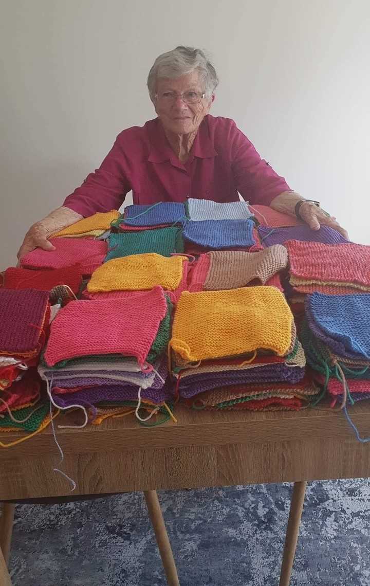 Member Rowena’s mother Peggy with some of her many knitted squares