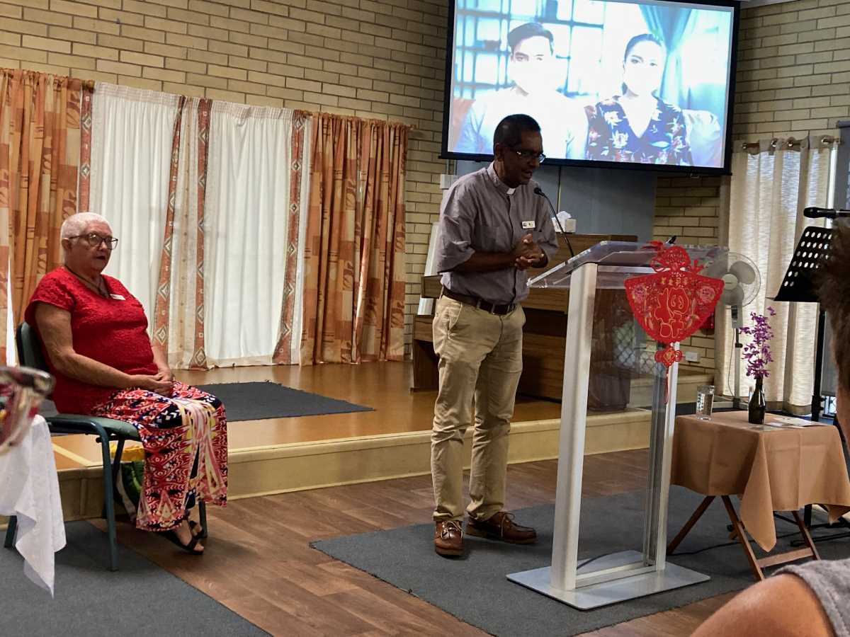 Father Shaji Joseph, Anglican Minister, leading The Lord's Prayer and Lillian Lochel, Coordinator and Leader
