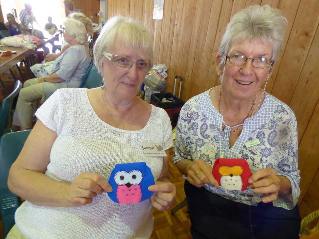Jacki Cross and Bev Phillips with the their owl purses made in felt