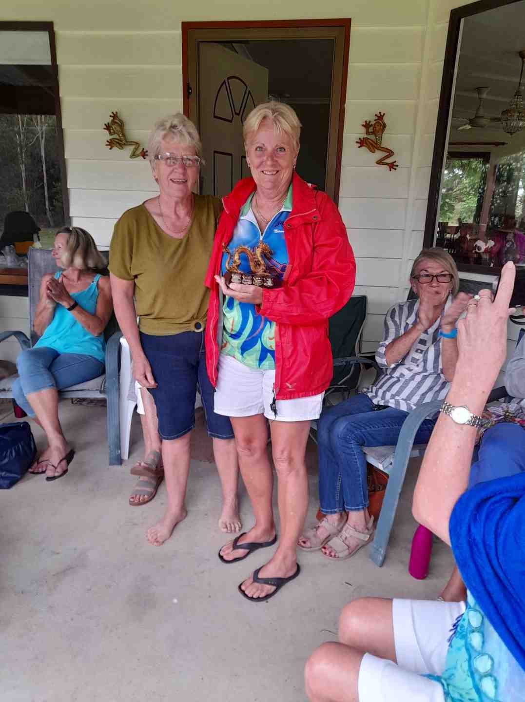 Cooloola Dragon Boat’s Head Coach, Sandra Wooster, presents Coach's award trophy to Assistant Coach, Helen Hurworth 