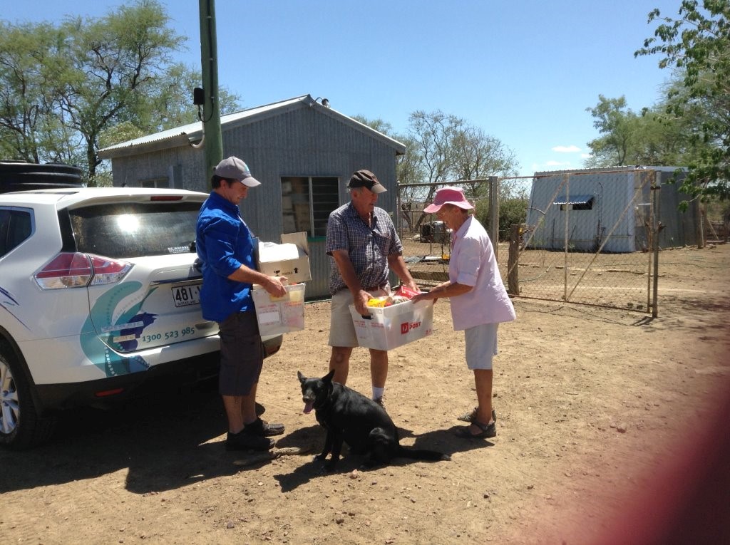 Handing over supplies to Jennifer McKay 60kms west of Longreach. They have been on a 60,000 acre family-owned property for 103 years. This is the first time this family has apparently asked for help. It was hard, they battle on and on - and still about 8000 sheep. As you can see they missed the rain.