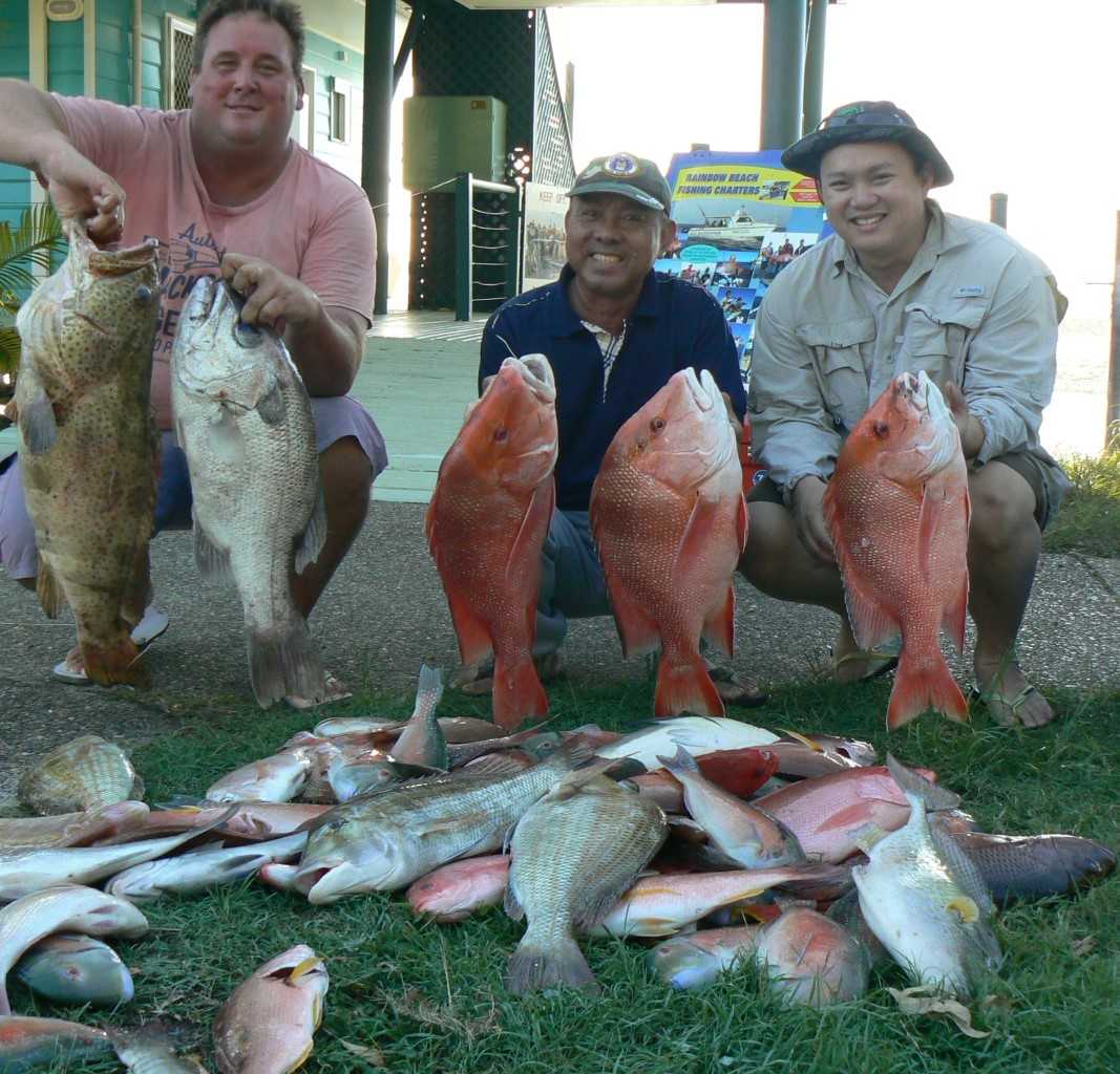 Mick with his cod and 4.7kg pearl perch, Nguyen and his father with a nice haul.