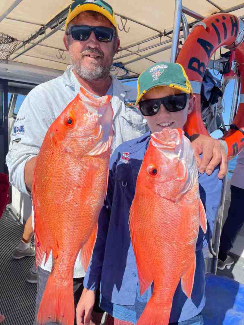 Out of Baitrunner - Dave and son Will with a nice pair of Scarlets to add in their colourful eski while fishing on Baitrunner