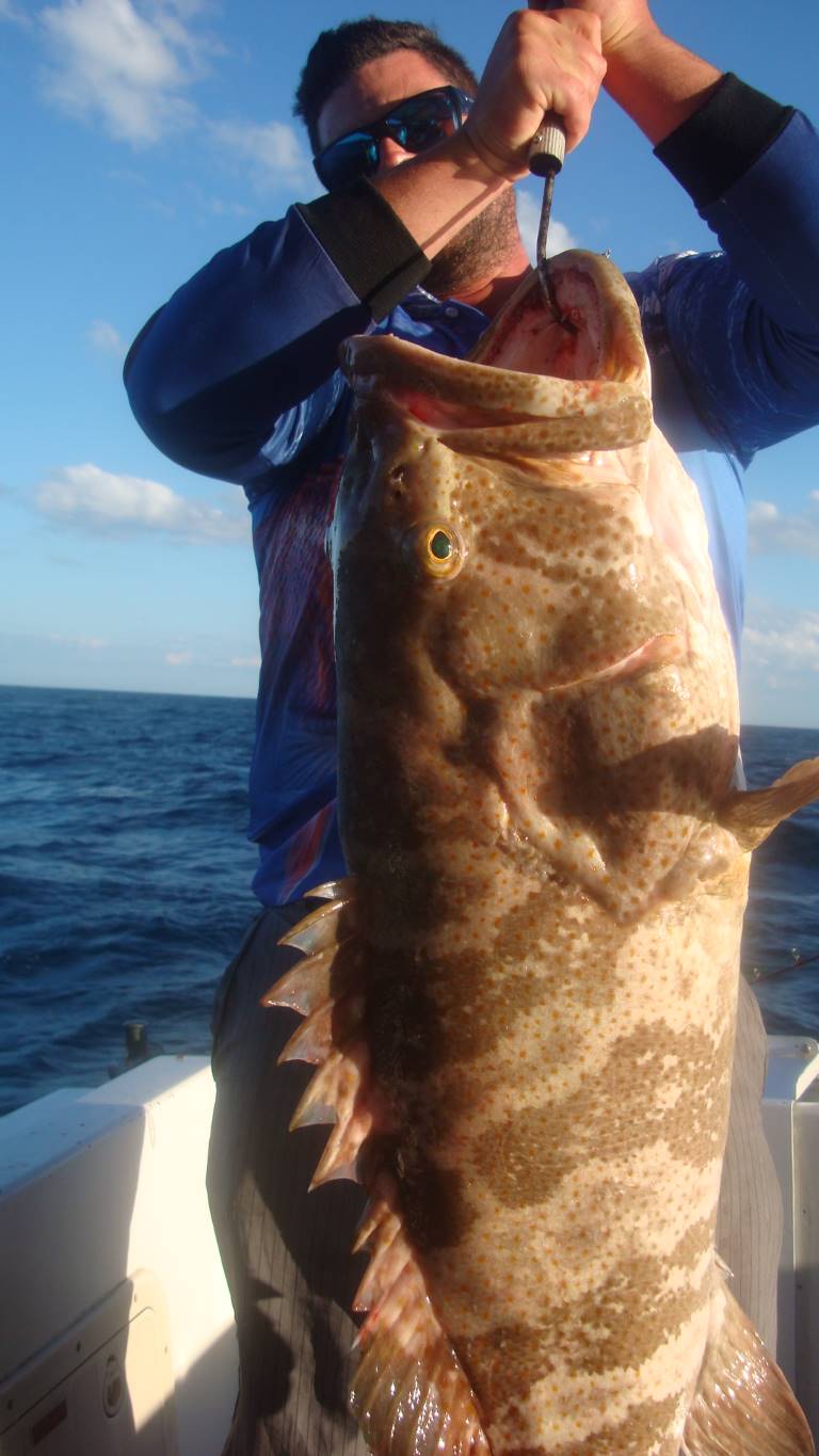 Travis struggled with his monster cod for a photo