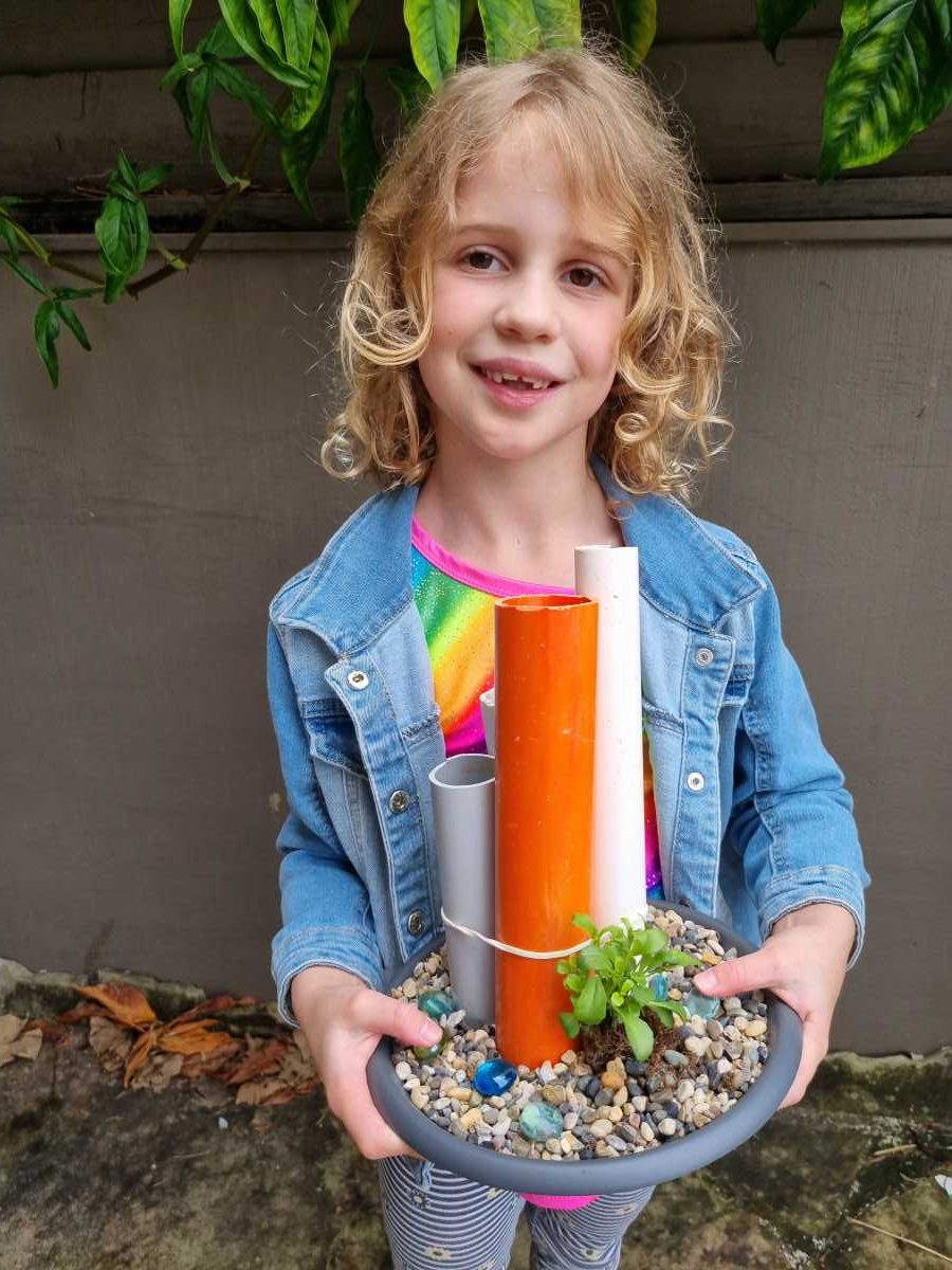 Silvie shows off her finished frog hotel, ready to welcome some green guests.