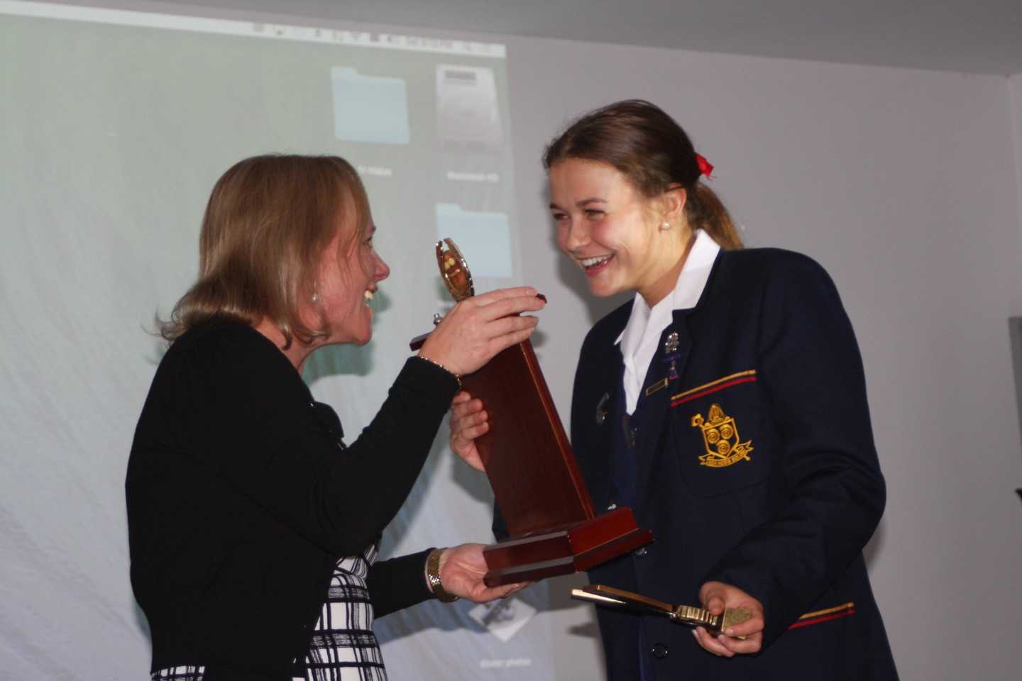 Principal Dr Julie Wilson Reynolds presents Kate with the Ammonite Award - St Hildas's Rowing's highest honour