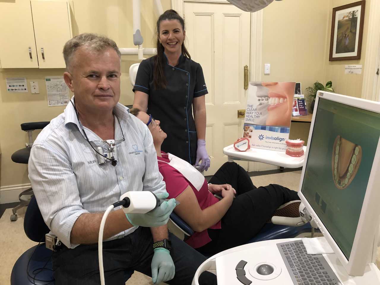 Channon Lawrence Dental’s Dr Mark showing Dental Assistant Kym and Oral Health Therapist Ashley (seated) the latest Invisalign scanning computer and software 