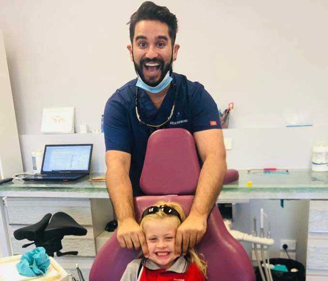 It is all smiles for Dentist Joel Pavy and Izzy Antrobus because eligible families receive free dental with NO GAP!
