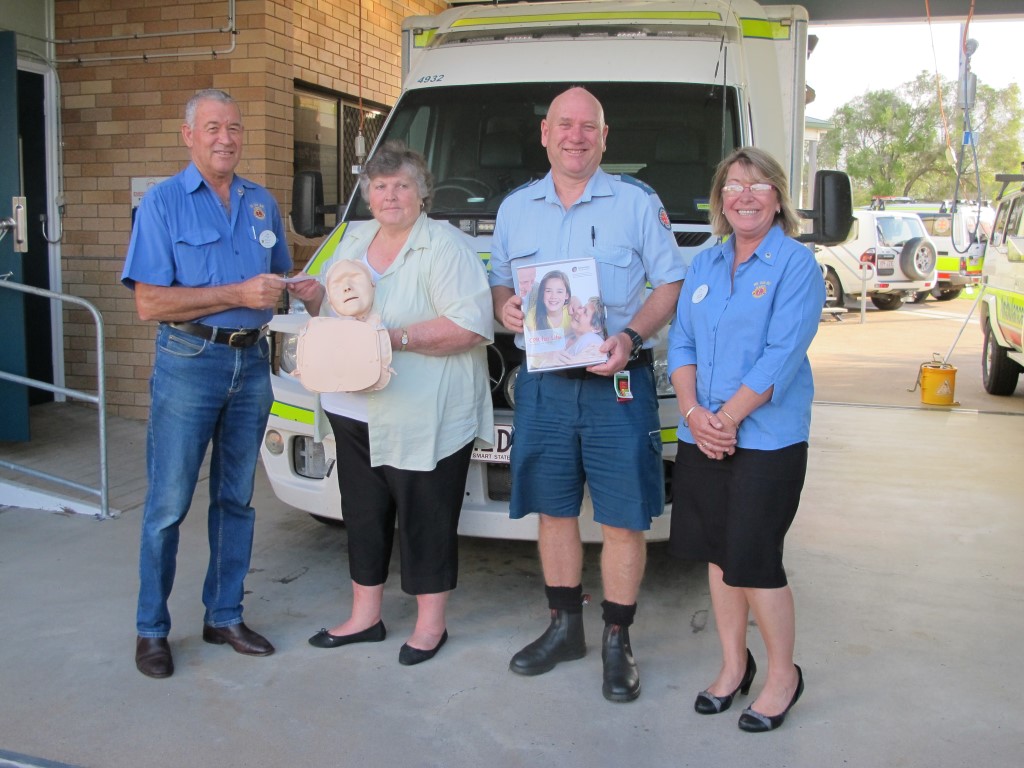 TCB Lions Philip Davey (President) and Rachel Fender (right) present a cheque to CCLAC President, Lillian Clark with one of the manikins, QAS Cooloola Coast OIC Wilbur Fahey Image supplied