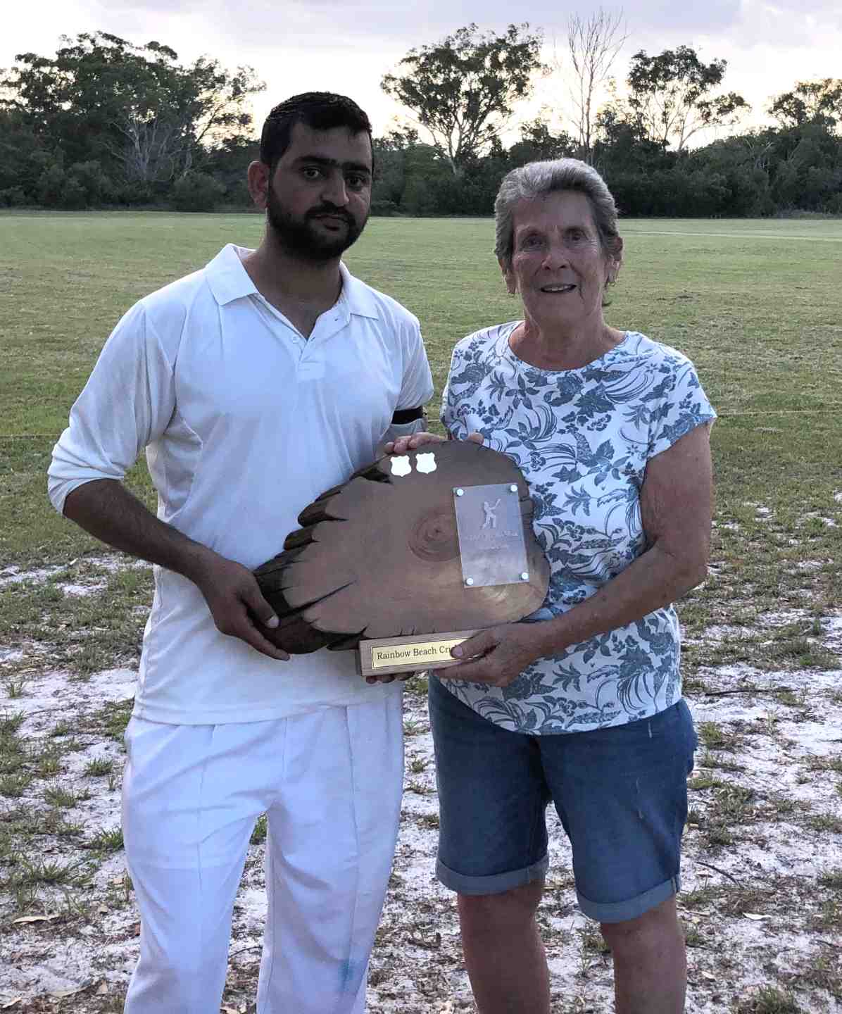 Muhommad Adeel Abid and Edith McBride with the Man of the Match trophy