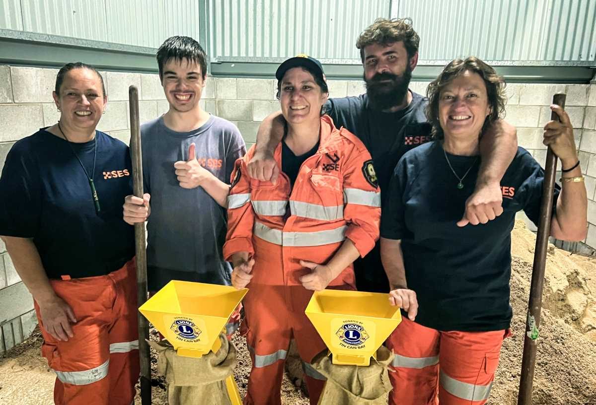 The Rainbow Beach SES crew give a thumbs up for the donation of the stands