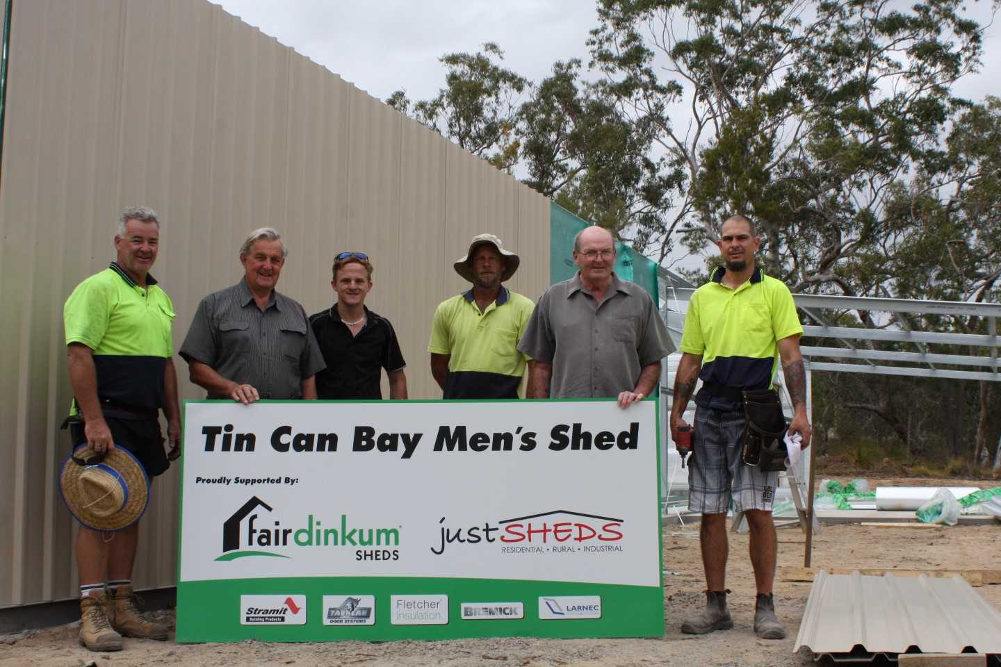 Holding the sign are Brian Linfield and Jamie Barnes from the Tin Can Bay Men’s Shed; they are delighted to have the Just She