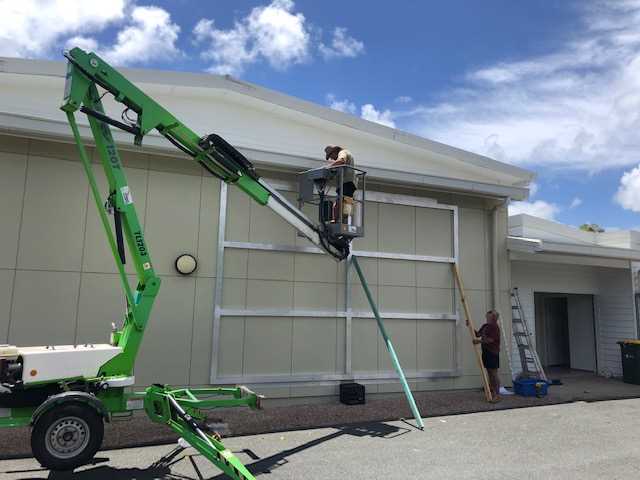 - Dave Fawcett from Rainbow Elevated moving the frame into place. Photo credit: Scott Taylor.