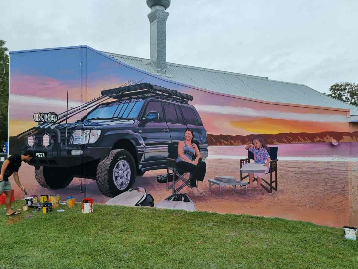 James R. Ellis as he was painting the mural privately commissioned by Rainbow Beach Pizza at the IGA Complex. Will he be the artist for the water tower mural? We will keep you posted!