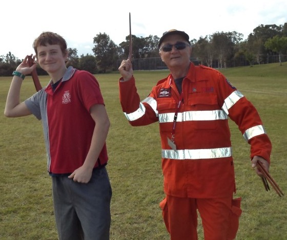 Lochlan Embury with SES volunteer learning to throw a boomerang