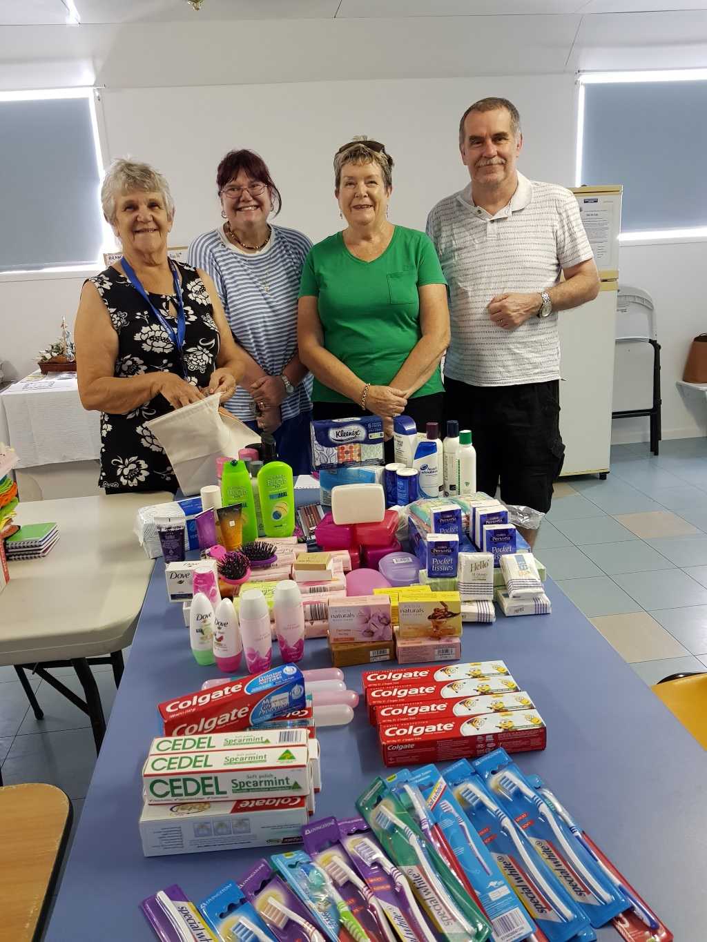 QCWA Member Joan, Debbie, Dawn and Mark with some of the Care Pack items