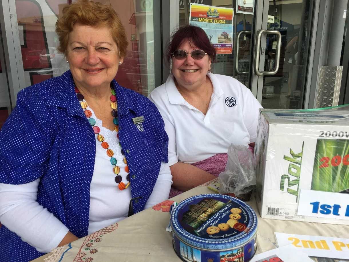 Irene Manwaring and Debbie Vines selling QCWA raffle tickets