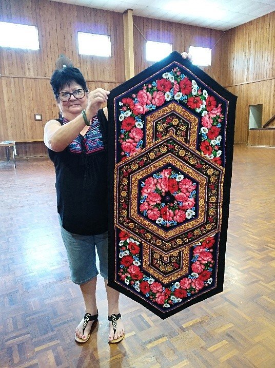 Leonie from the Tin Can Bay Quilting Club with her dazzling table runner