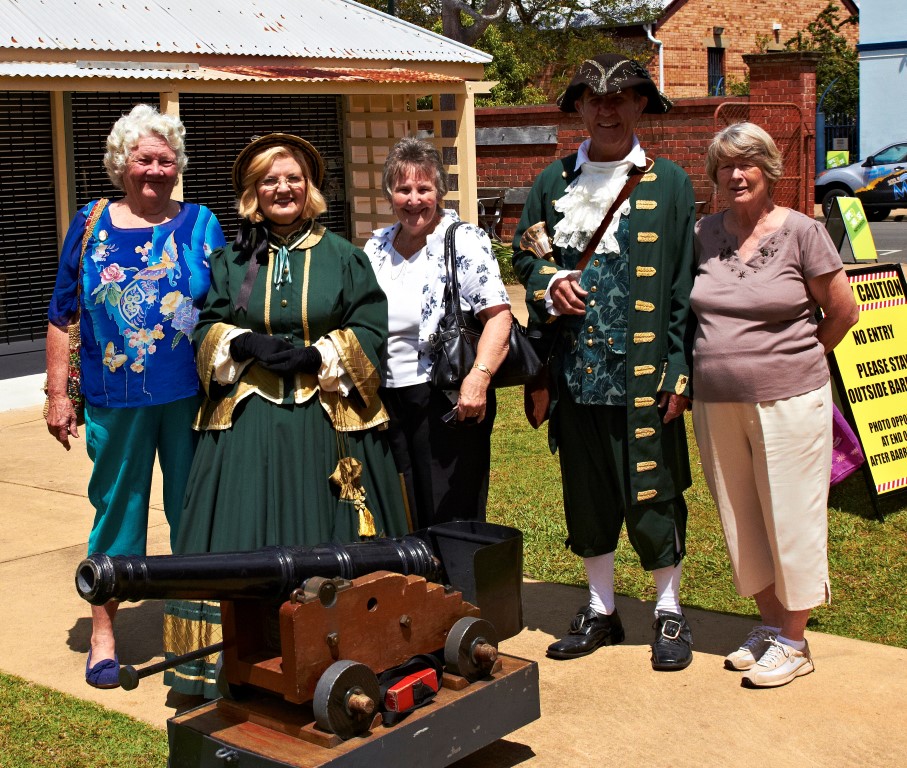 Margaret, Dorothy and Nola helping the town crier prepare the cannon for the midday firing.