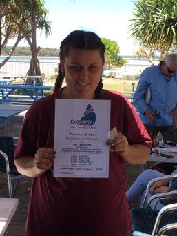 Ella Beauchamp with her Certificate of Achievement from Sailability at Tin Can Bay