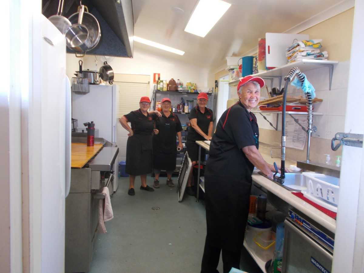 Tired but happy Dragons cleaning up after a busy morning in the Dragon's Lair Cafe at the TCB Markets. L to R: Sandra Wooster