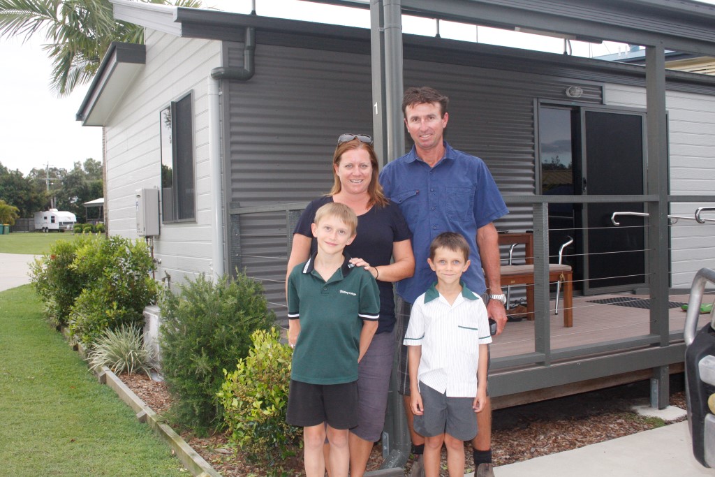 Melanie and Steve May with sons Thomas and Jackson outside one of their cabins, growing in number at the Tin Can Bay Tourist Park