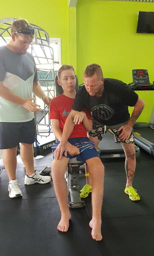 Tristan Sik is building strength with Dad and Personal Trainer Mark at the Rainbow Beach Gym Image supplied