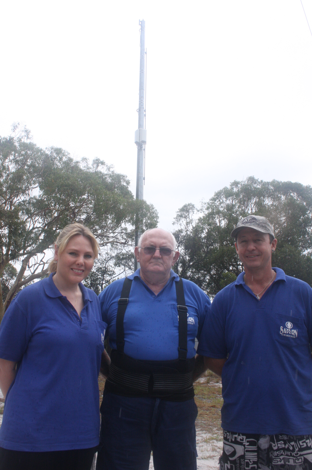 Saturn Antenna's Laurinda Spencer, Rod Farr and Tony Grant at the tower, only metres from their workplace but since the retune, say their TV reception is patchy or nil