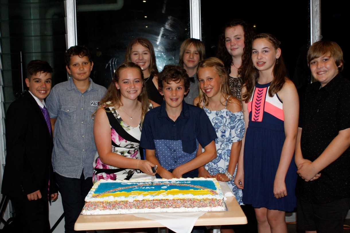RBSS graduates Jarrod, Archie, Annie, Zaraya, Charlie, Noah, Emma, Ivy, Ruby and Oscar are ready to cut the cake at the Surf Club!