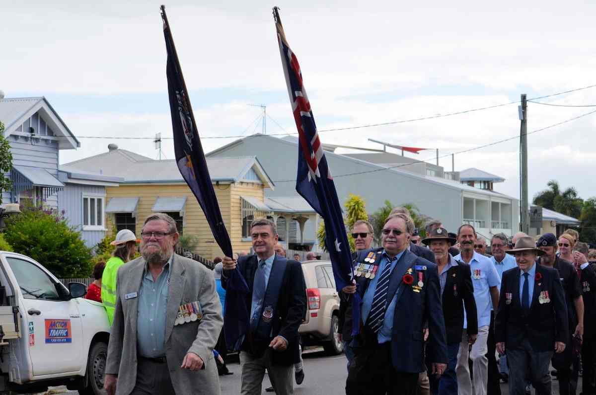 Tin Can Bay RSL President Don Holland leads the march