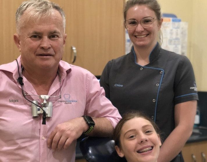 Emily-Jane Davey very excited to be finished orthodontic treatment and have her bands taken off - here with Dr Mark and Denta