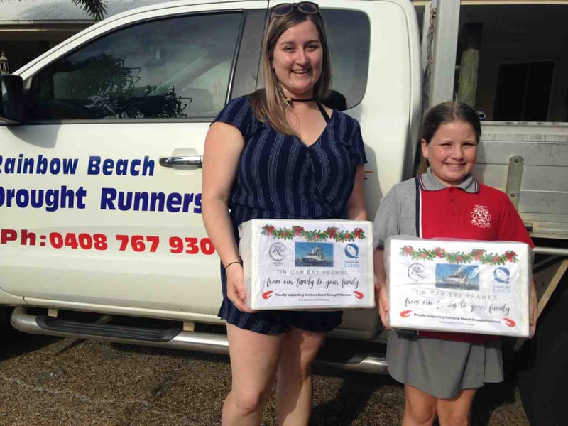 Droughtrunners - Paige and Mia Reibel with a couple of the 40 boxes of prawns donated by Reibels Fishery