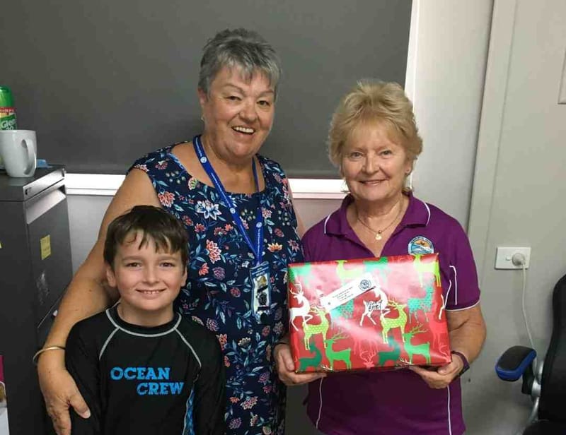 Santa’s helper, Steven, Wendy from the CWA and Eileen at the Resource Centre accepting presents
