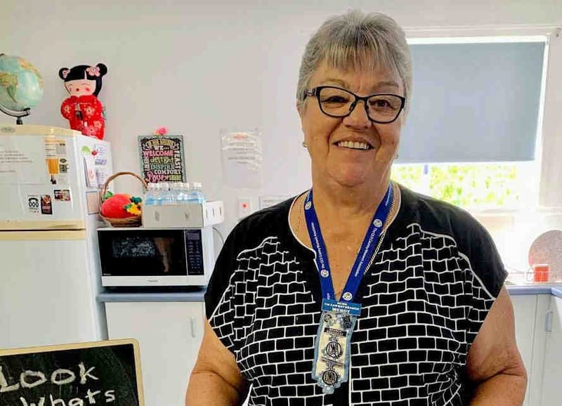 Branch President Wendy with a Trinidadian macaroni pie made by Country Kitchens Facilitator Gabriella