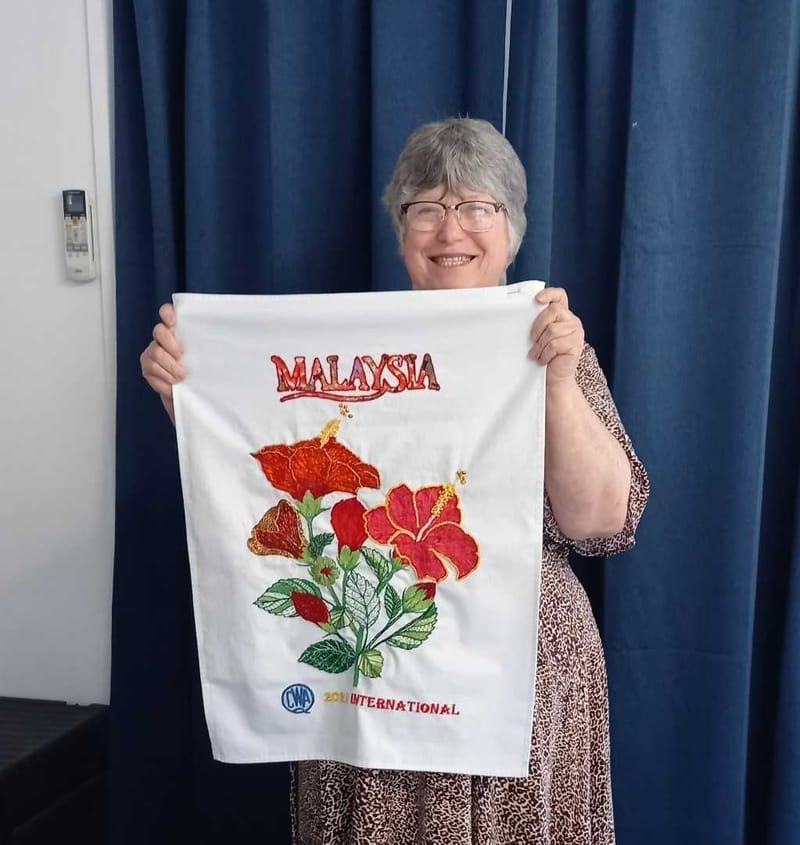 Dianne holds her International Creative Tea Towel Competition entry!