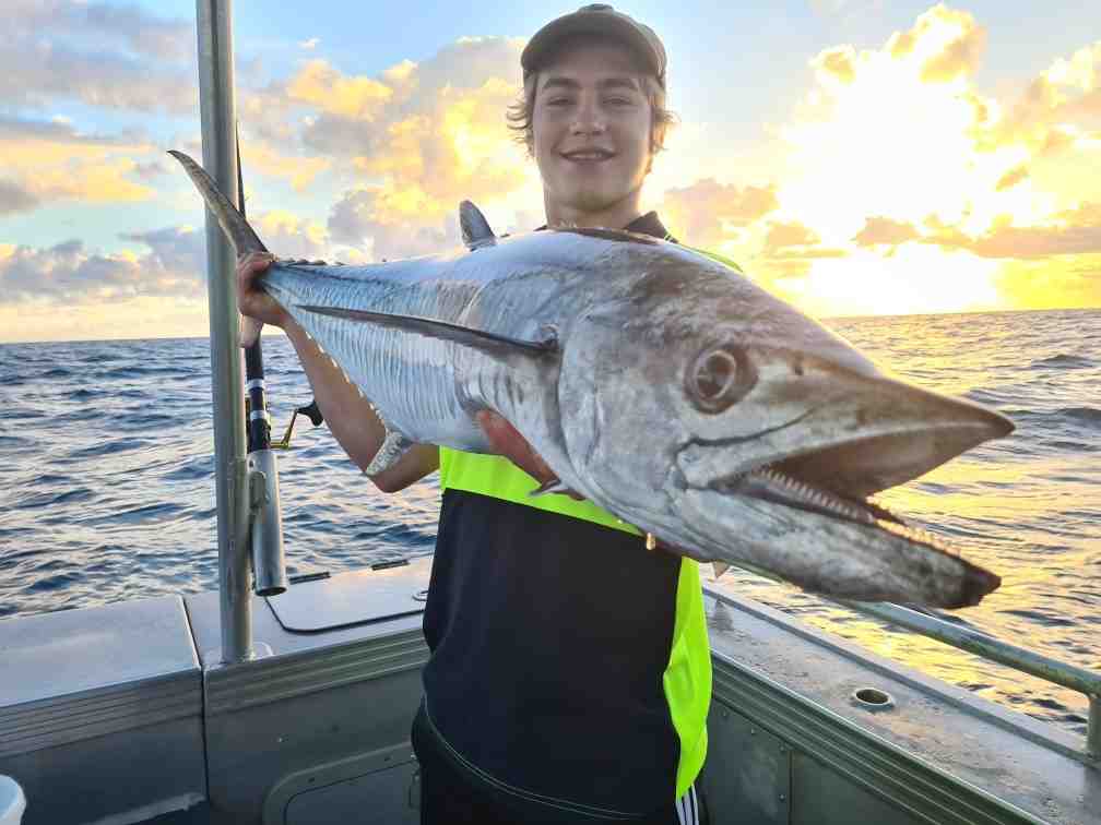 Pat with a cracking Spanish Mackerel while fishing on the Keely Rose
