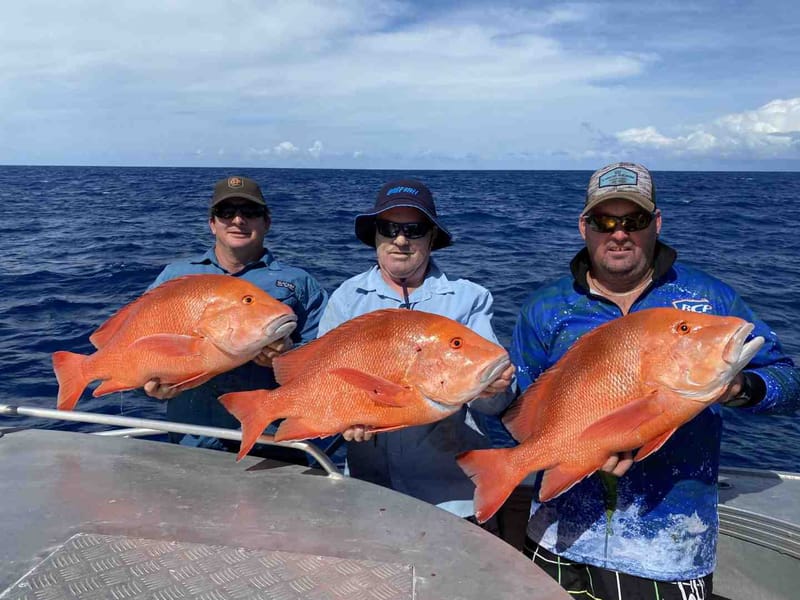 Happy guys fishing on the Keely Rose with a triple hook up on spectacular Red Emperor