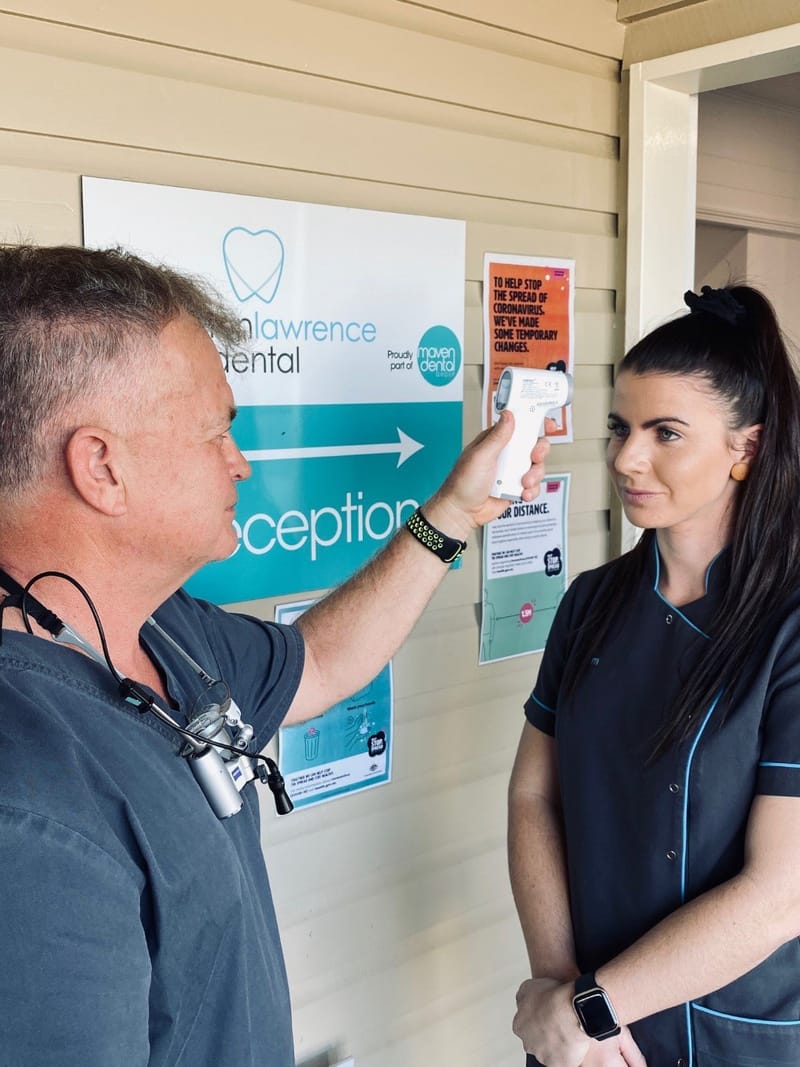 Dr Mark Cull checking Dental Assistant Kym Espin’s temperature which is done every day for the patients safety