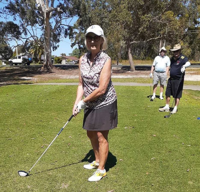 Jenny Skuja teeing off, with Barry Hudson and Lindsay Cullen watching