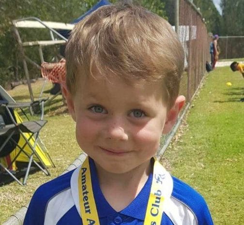 Hunter Groves proudly wears his bronze medal for shot put
