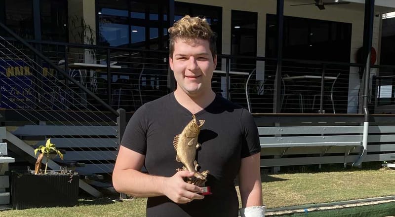 Liam Brady holds the photo named for his father, Peter