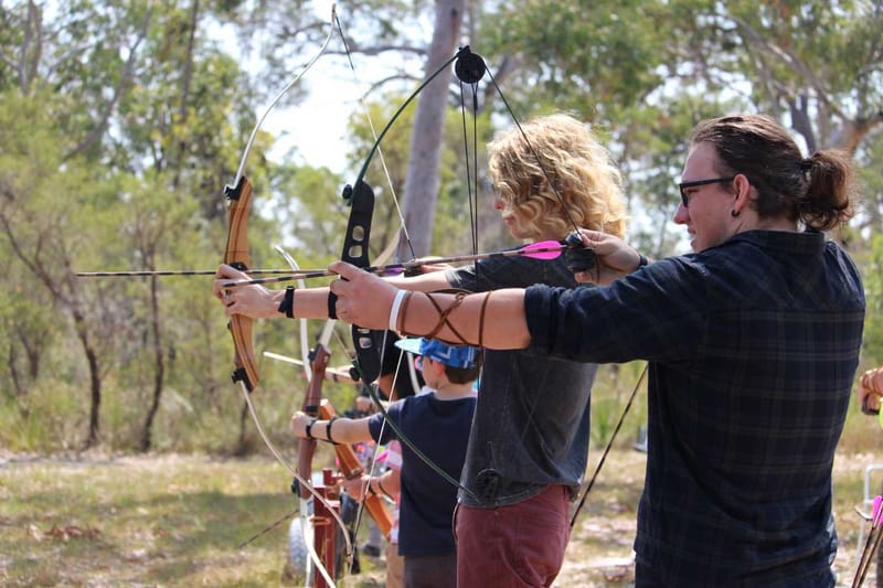 Zach and Braden about to let their arrows go at the previous archery activity day